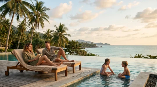 Family of four enjoying carefree vacation at resort poolside with tropical setting at golden hour